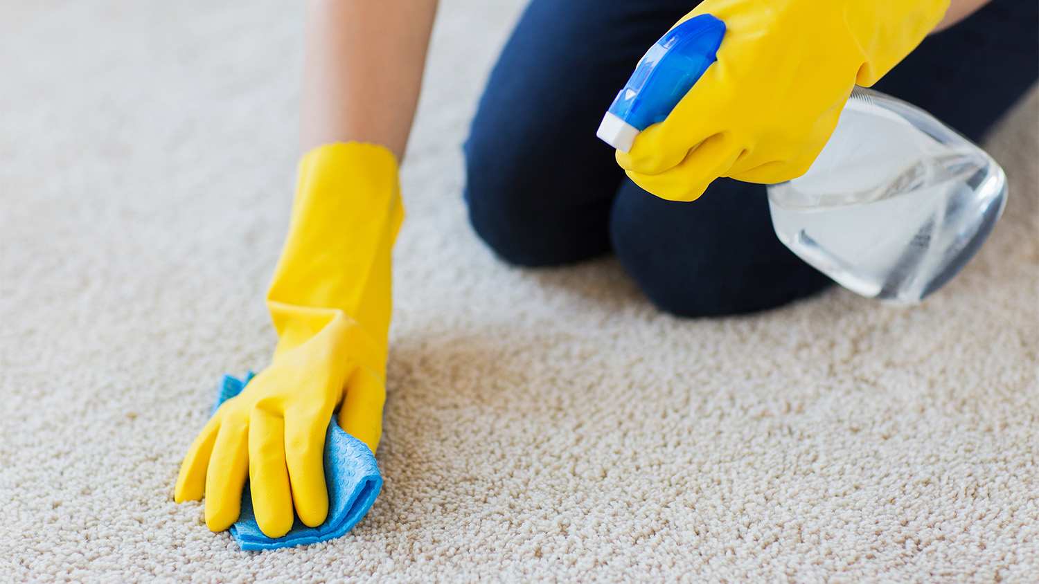 woman spraying carpet cleaner