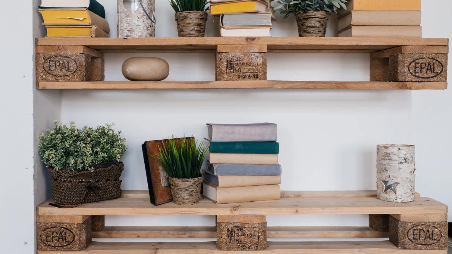 Floating pallet shelves with books and plants on them