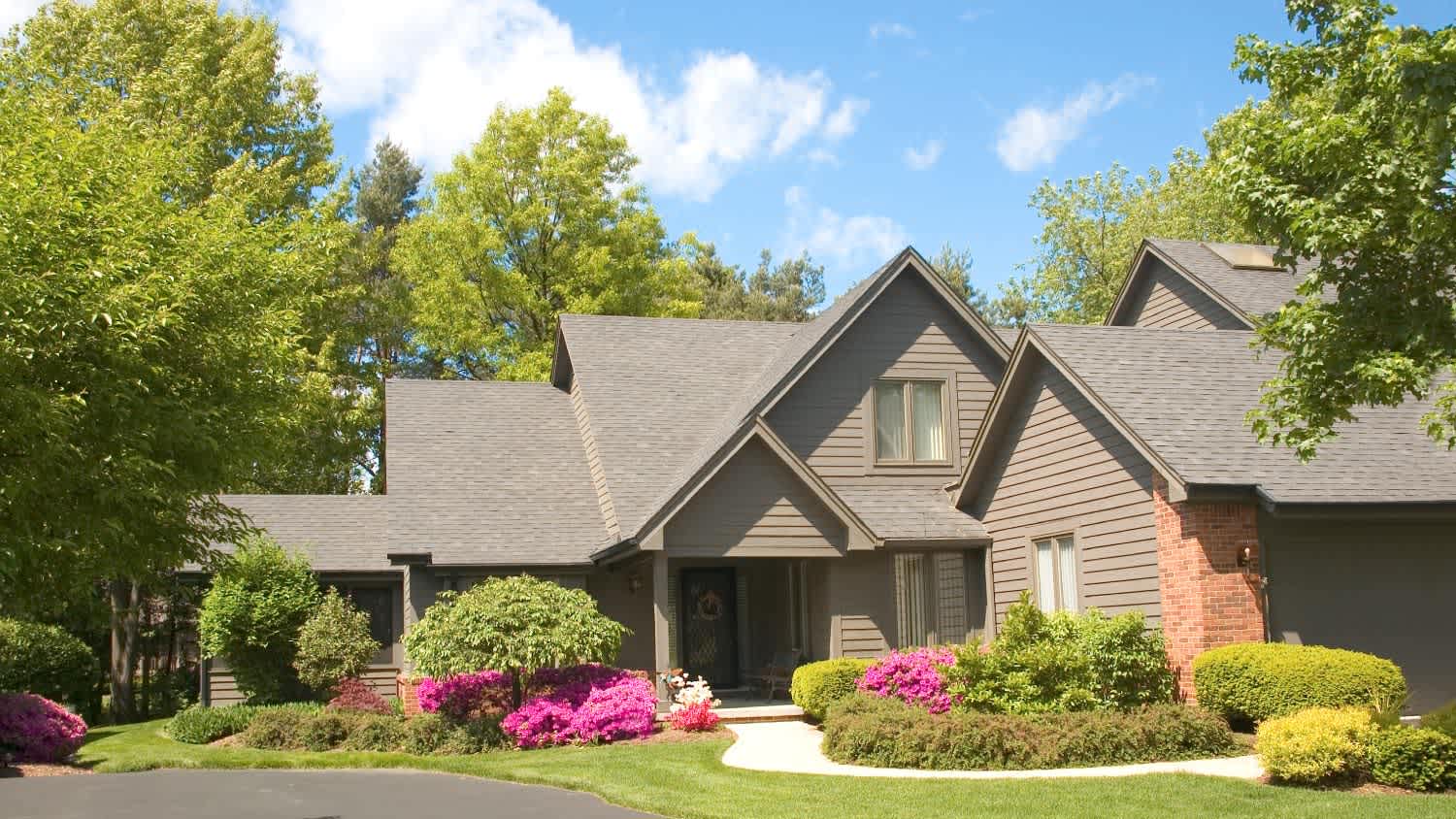 A house exterior with brick and siding trim