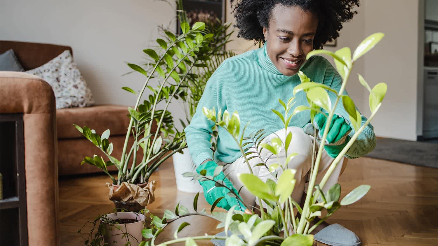 Woman home smiling houseplants