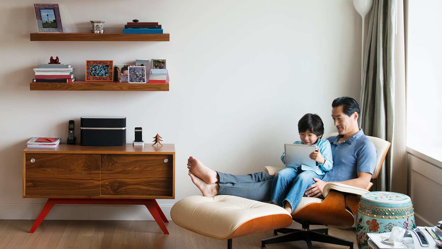 Man and child chair books shelves