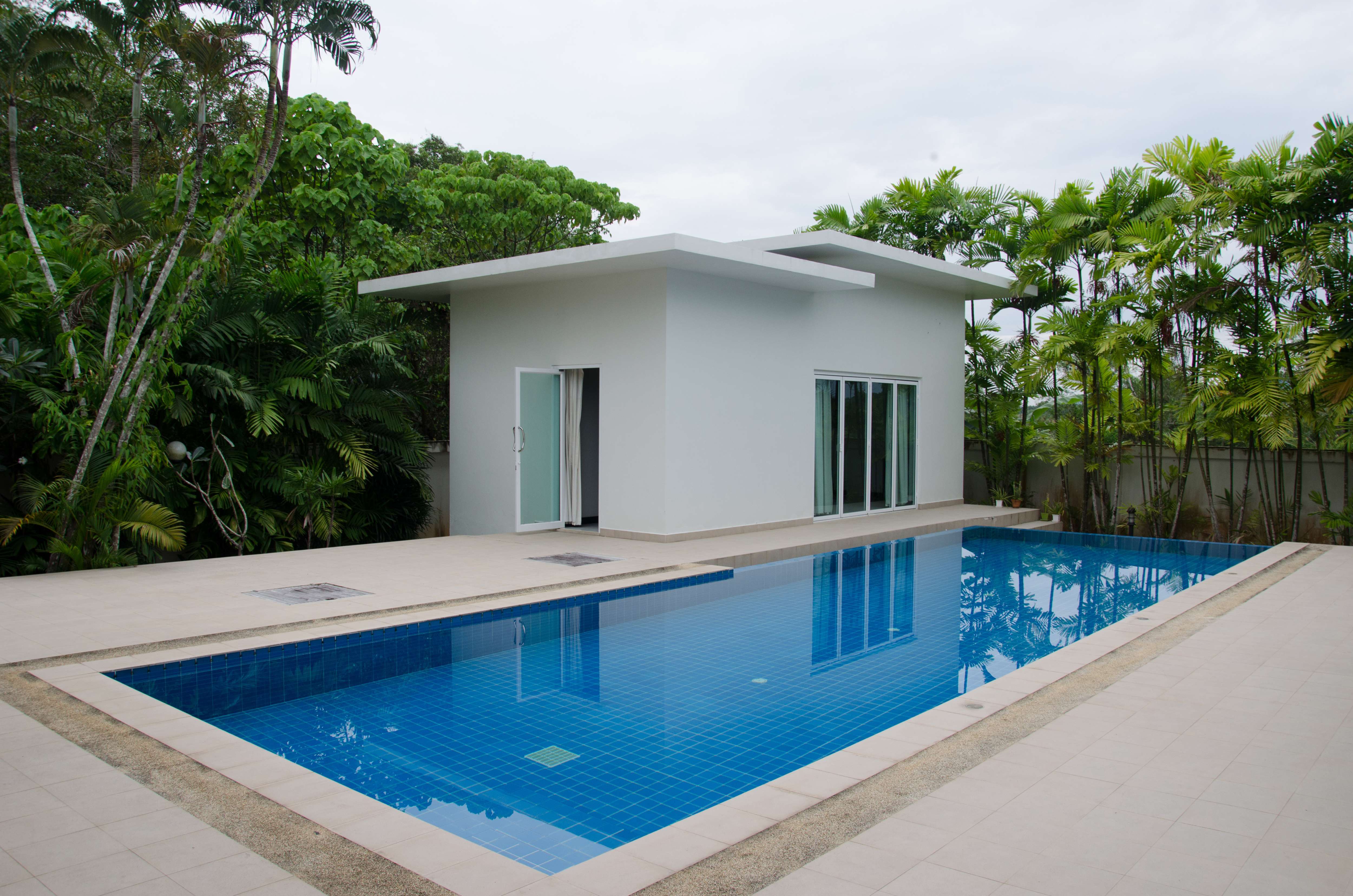 An inground swimming pool and a luxury guest house