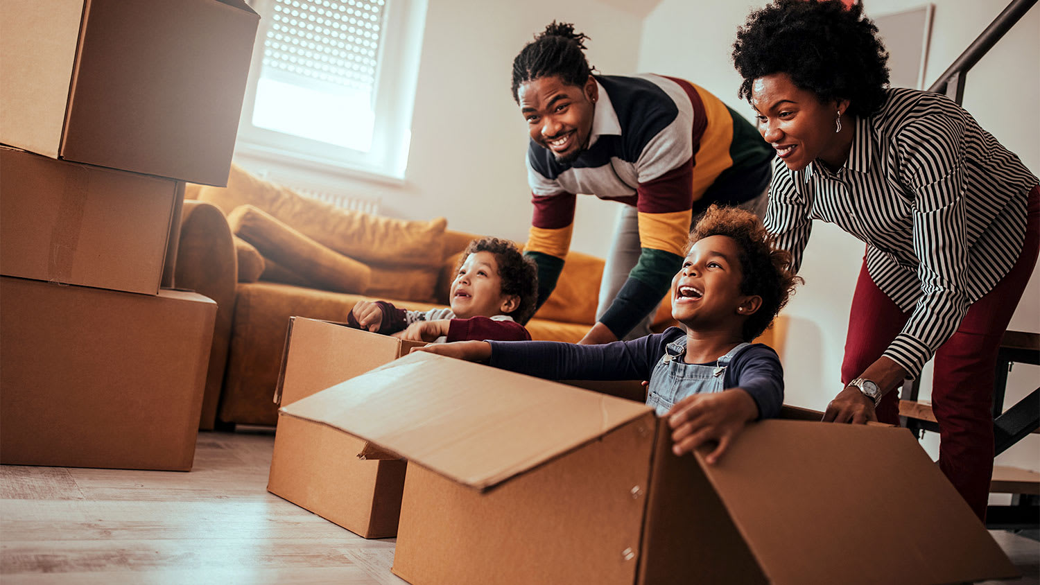 Family playing with moving boxes