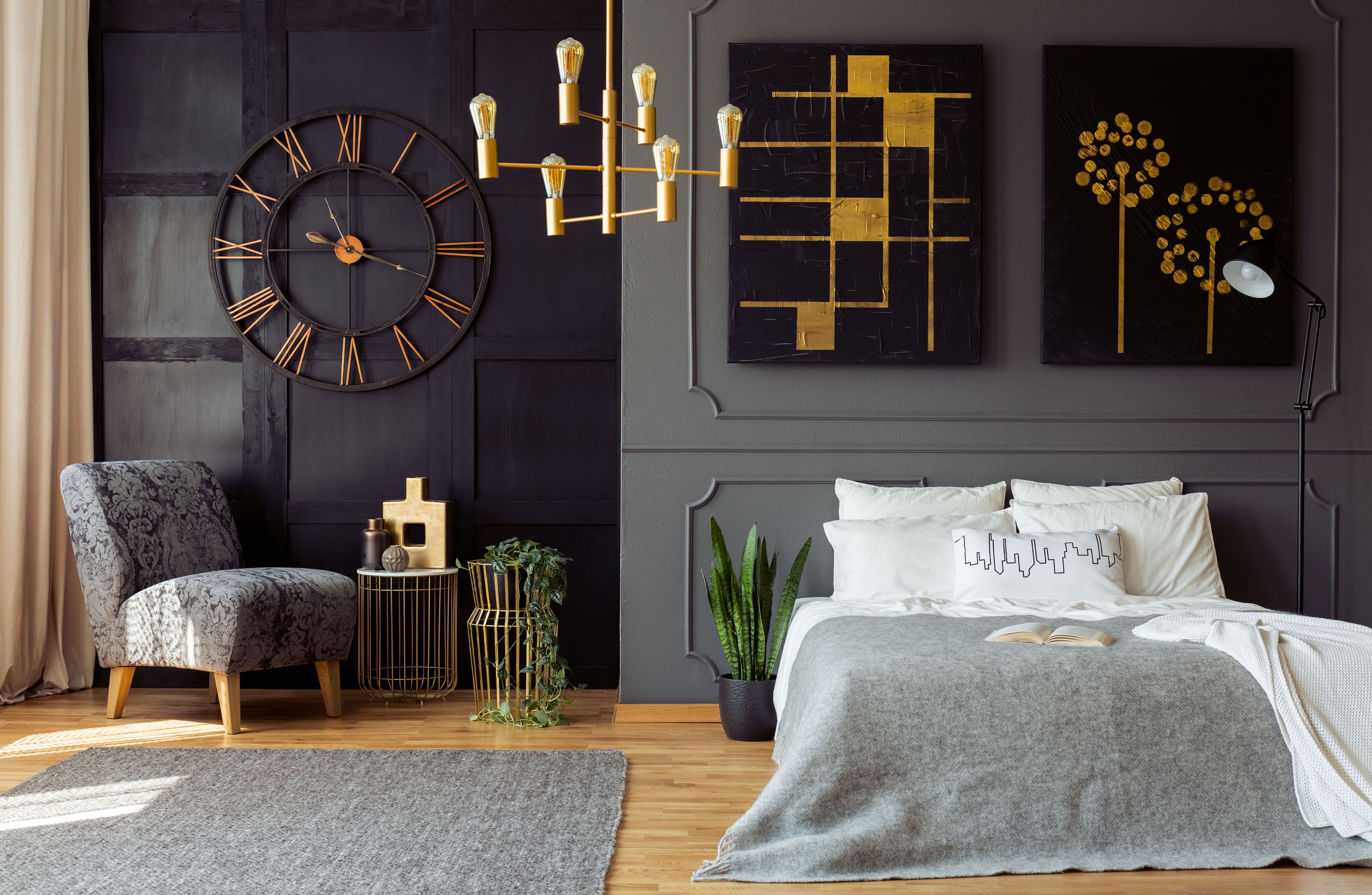 Dark-colored bedroom with gray and black wainscoting patterned walls