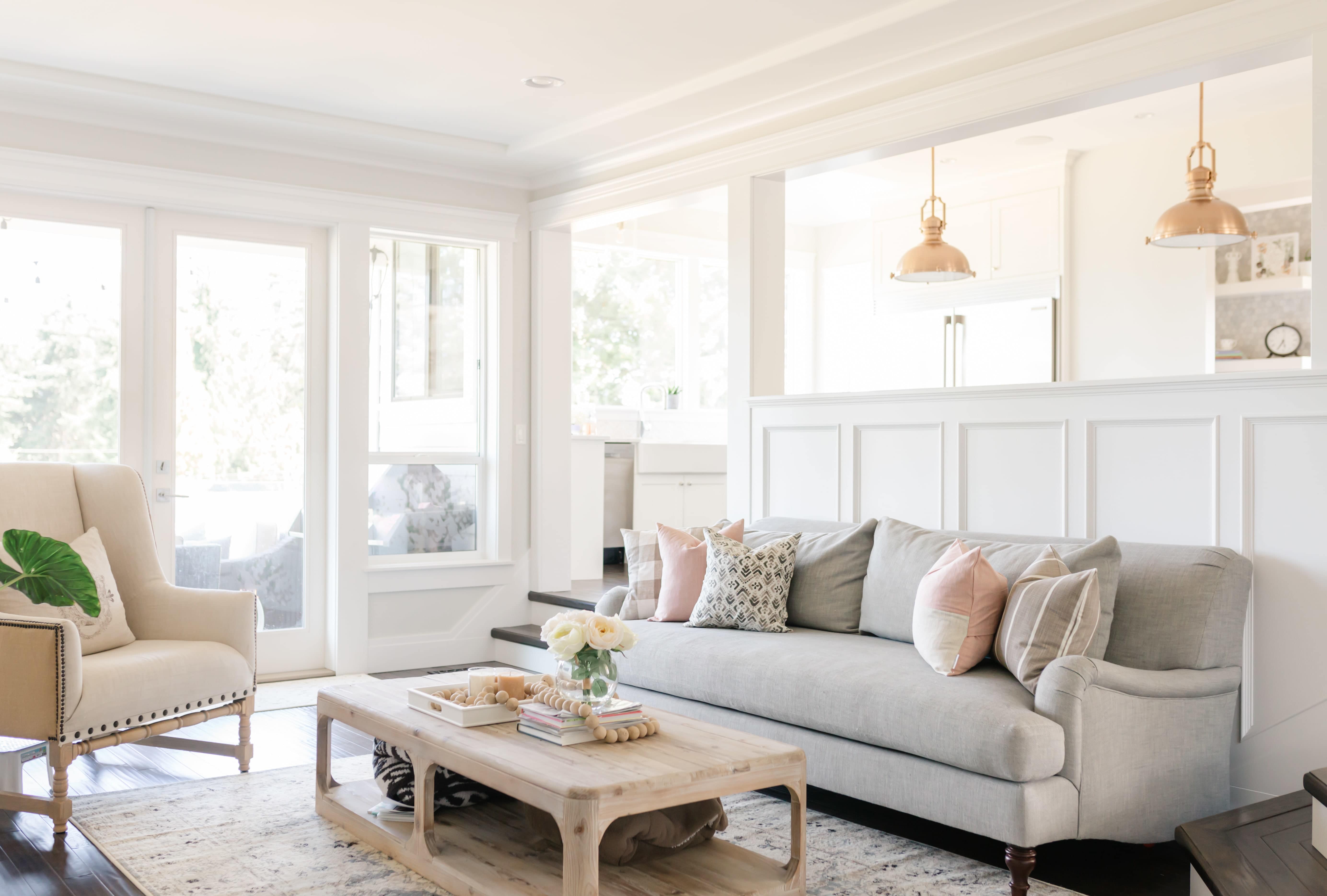 Bright, open living room with white walls and a section of wainscoting designs