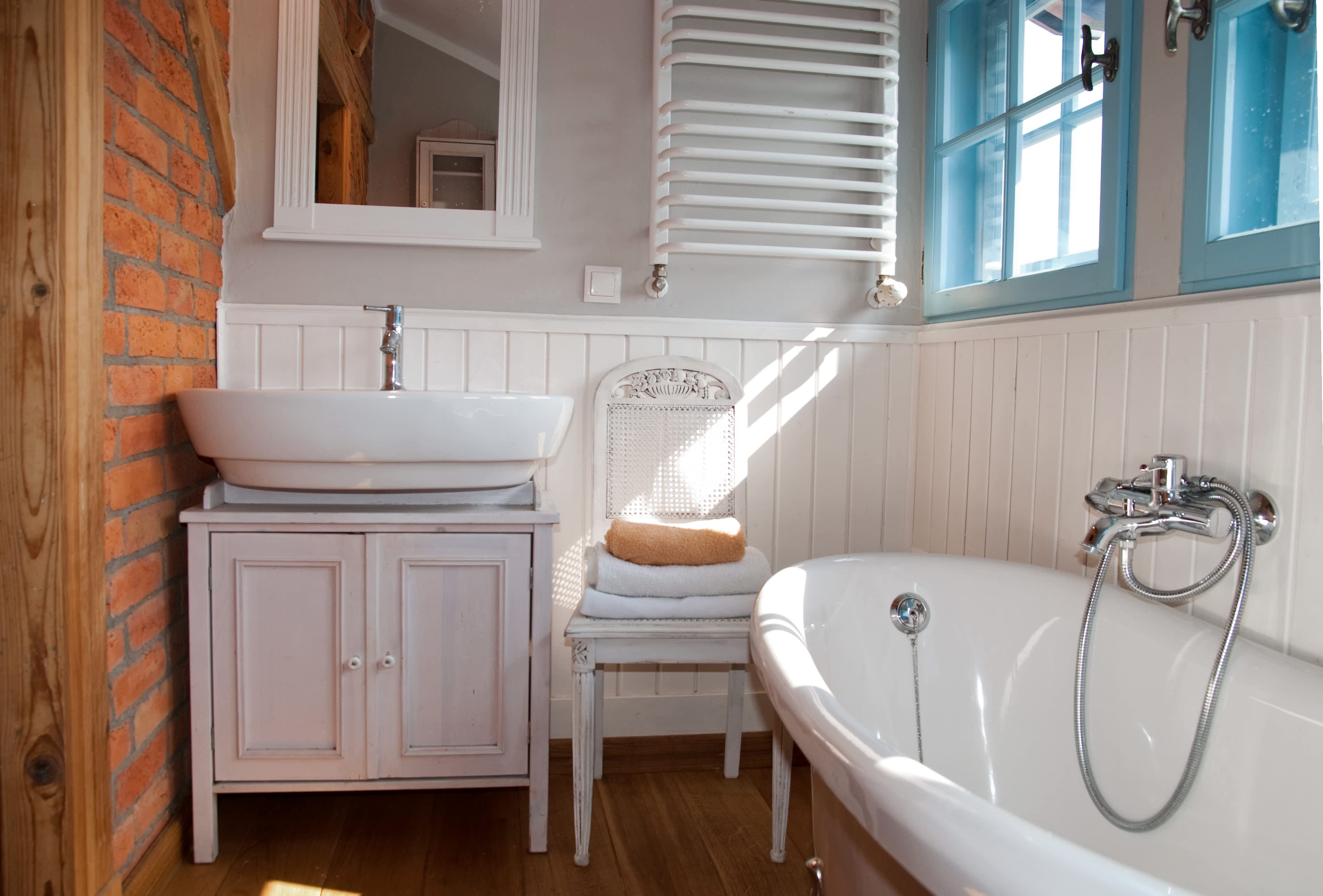Small bathroom wall lined with beadboard wainscoting