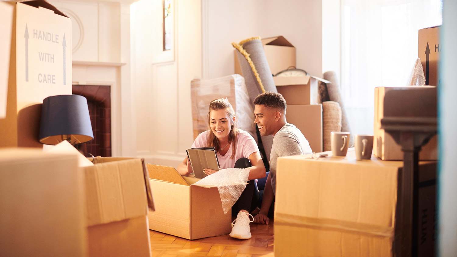 Couple packing moving boxes