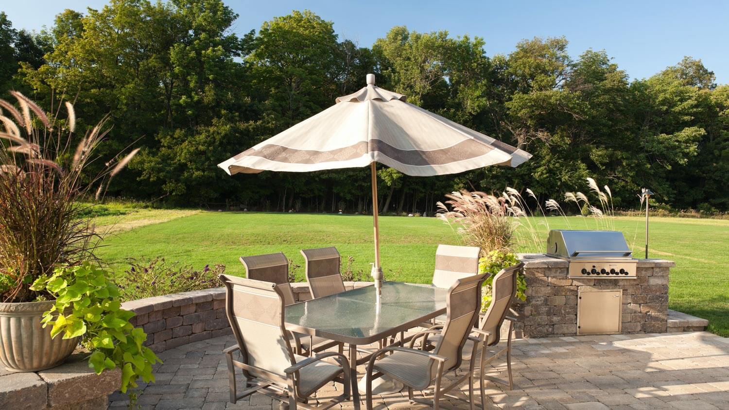 A patio with pavers in the backyard of a house