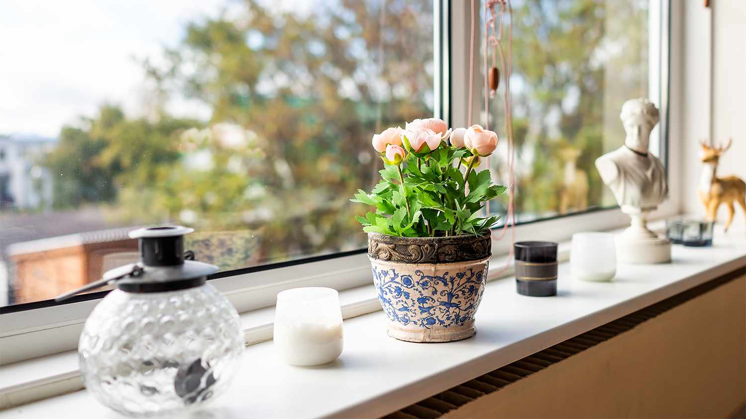 decorated windowsill with plants and candles