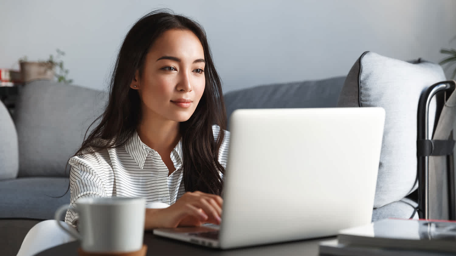 A young woman browsing on her laptop