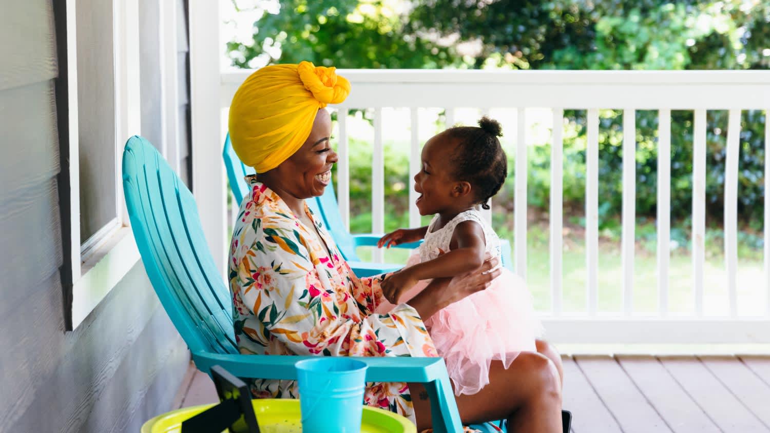 Mother and daughter sitting on front porch
