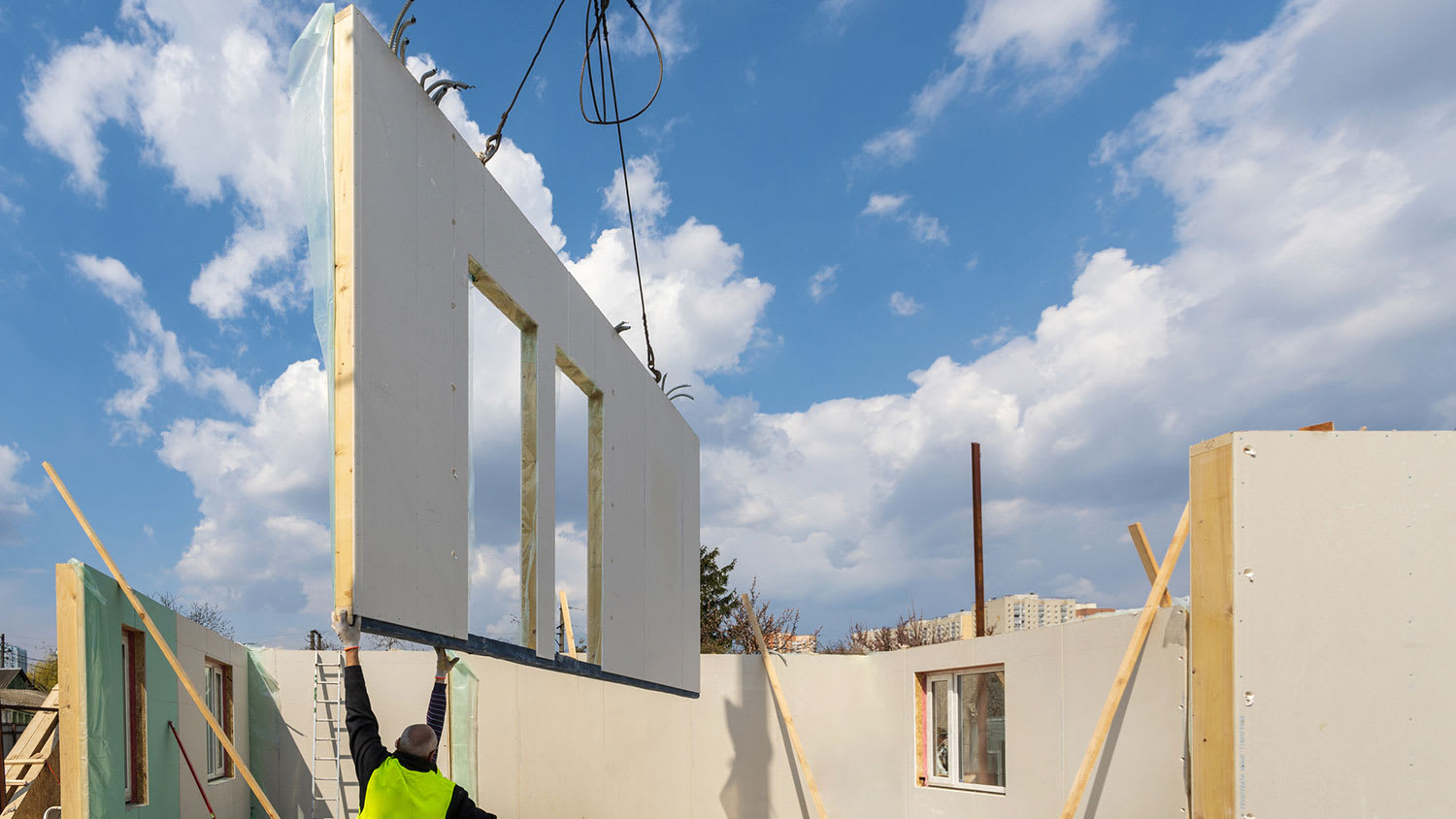 Crane moving modular house wall