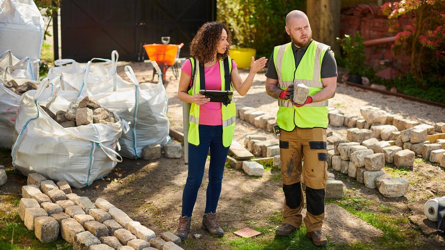 A landscape designer giving instructions to a worker
