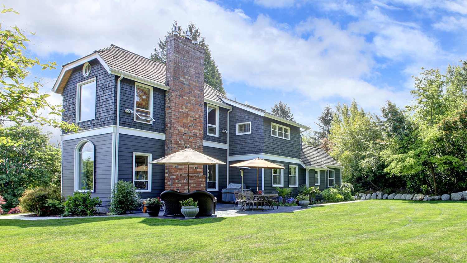 large blue house with large backyard