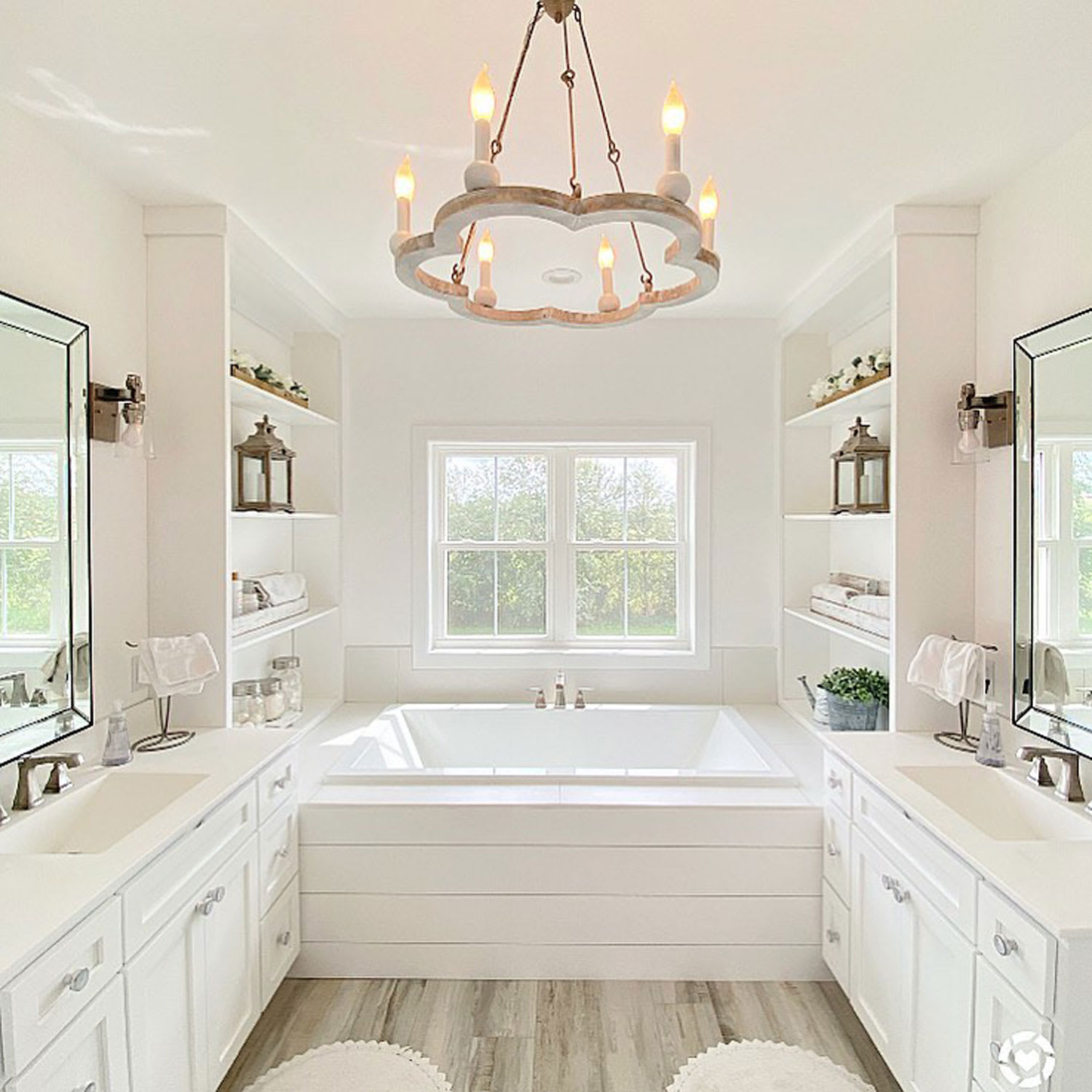 Bright bathroom with spacious bathtub and chandelier