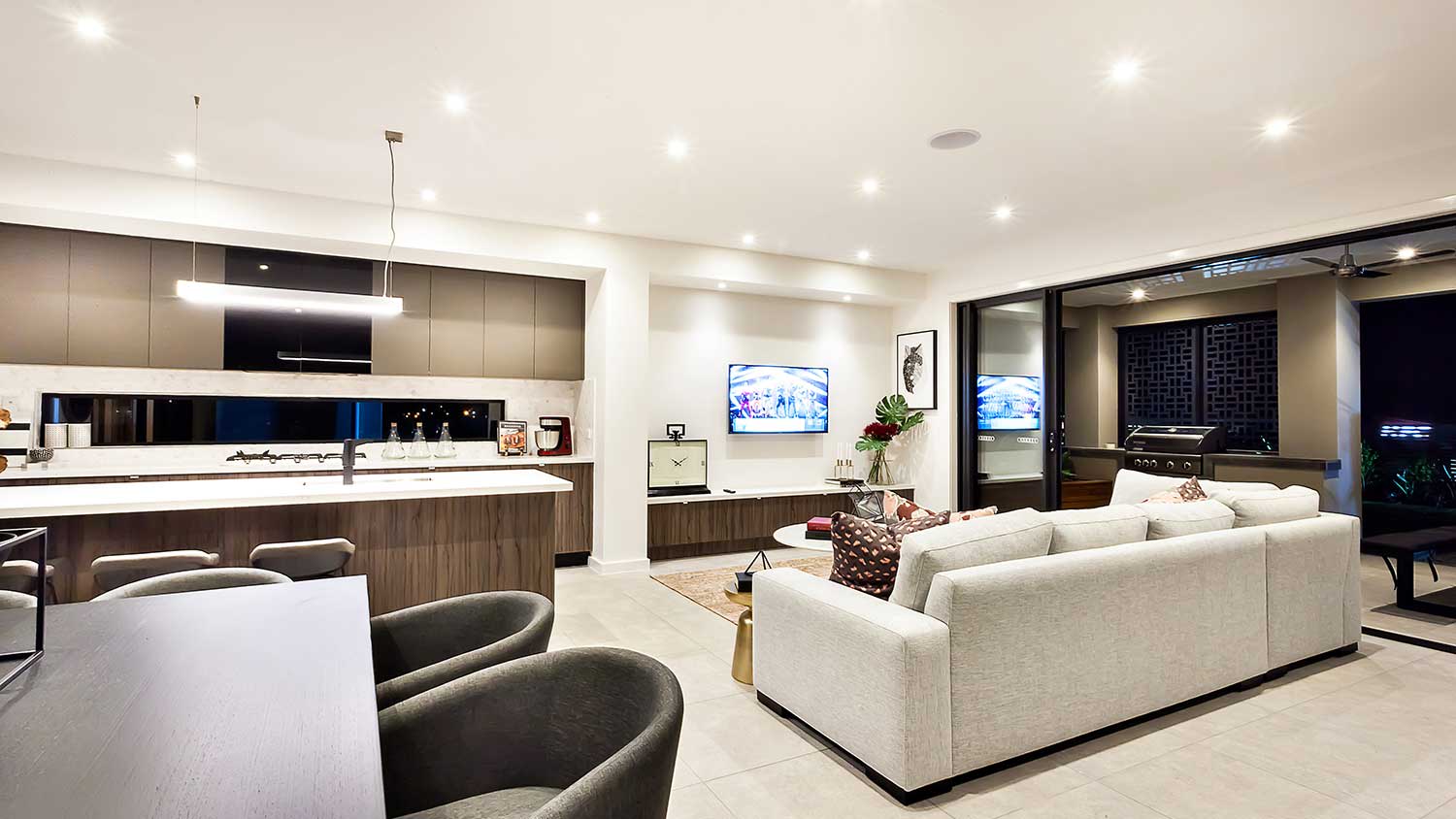 Modern open plan living space with lights on