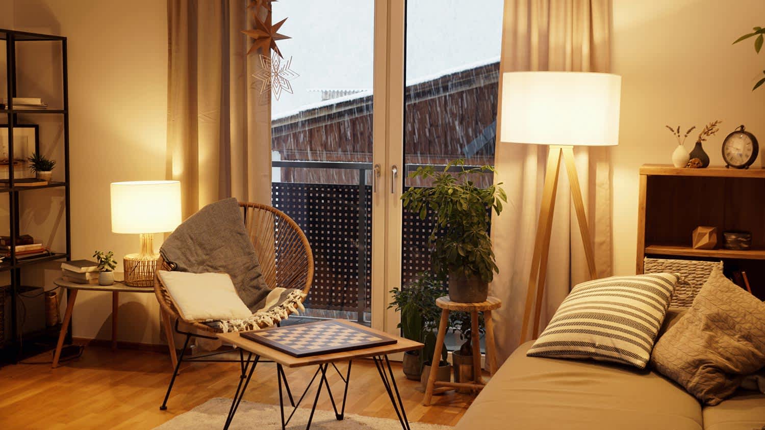 A warm and cozy living room at night with a snowstorm outside