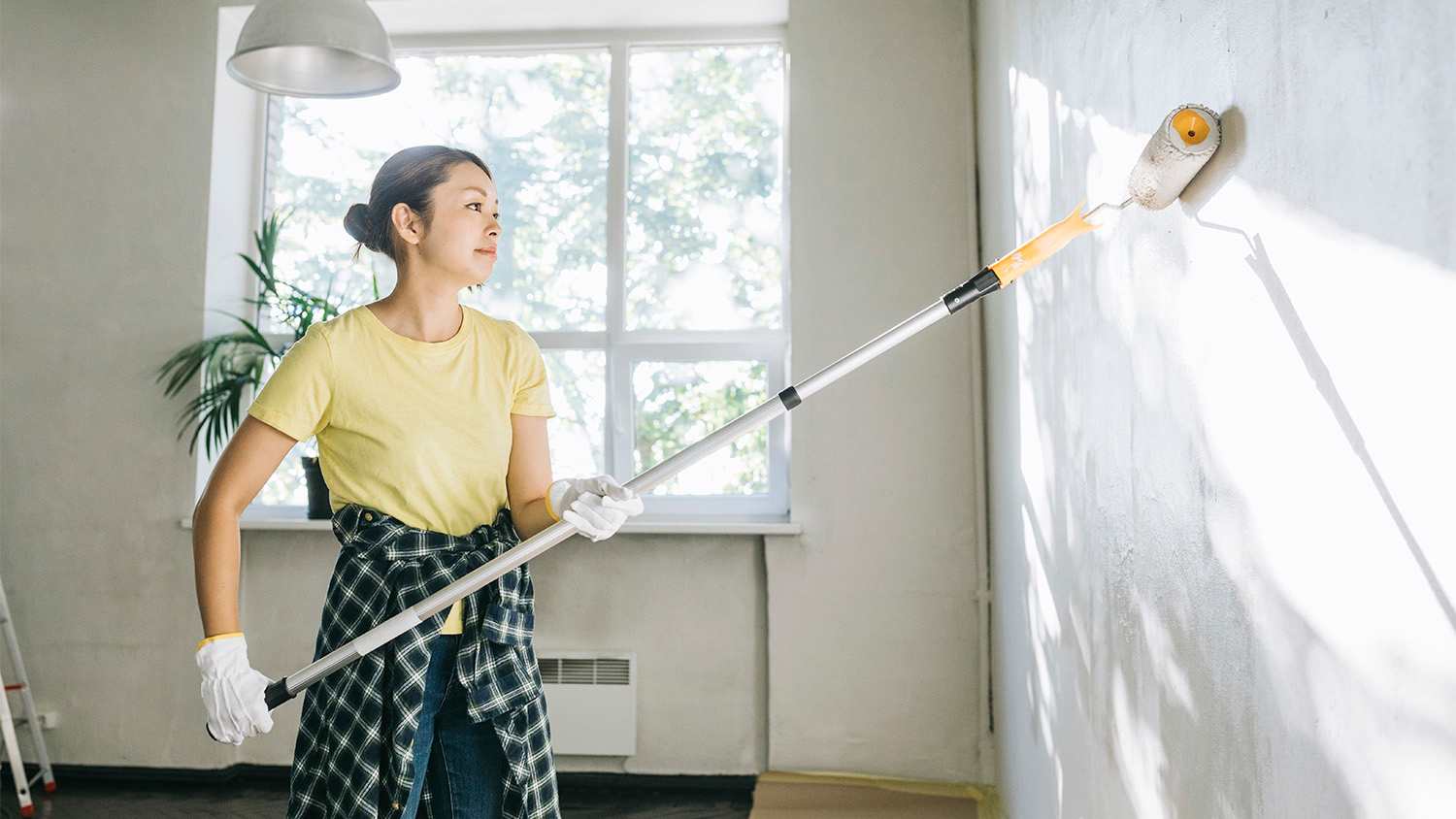 woman painting walls of her home white