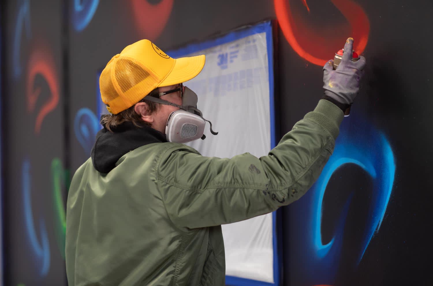 Folek painting a mural