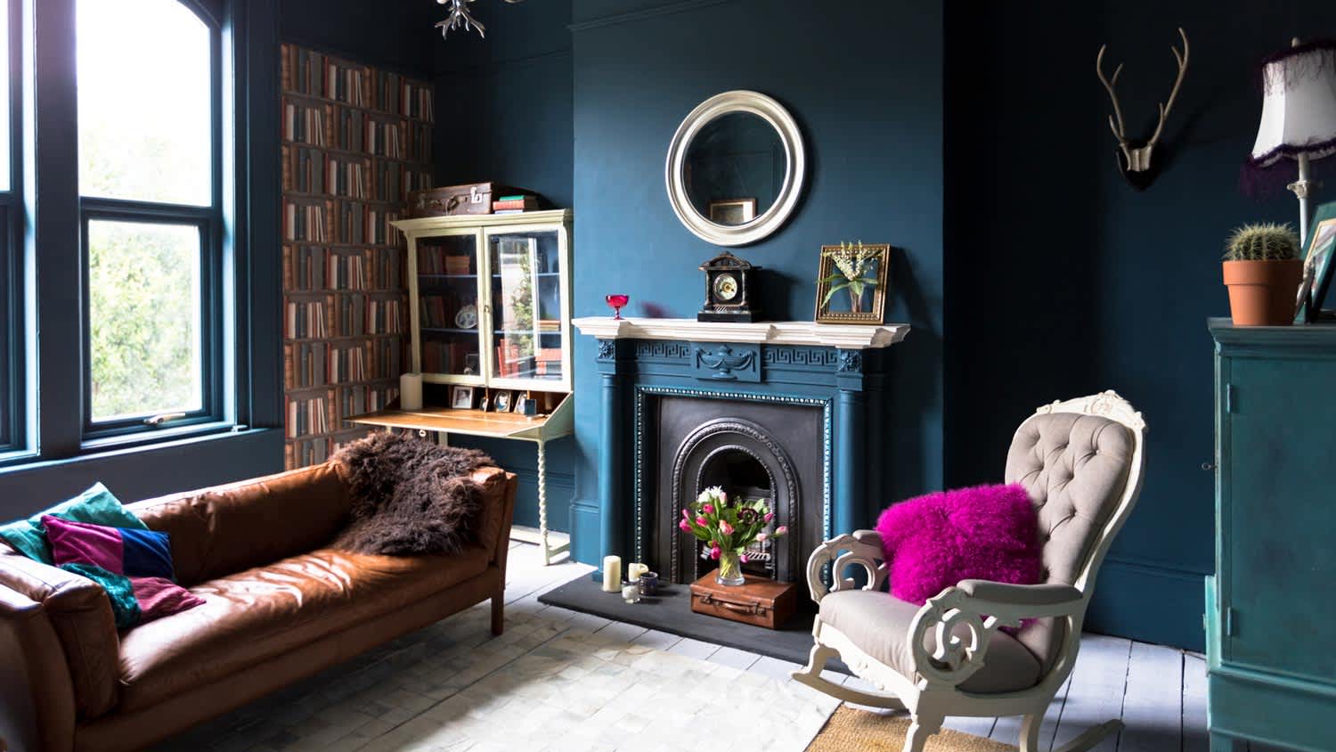Α fashionable vintage living room with blue wall