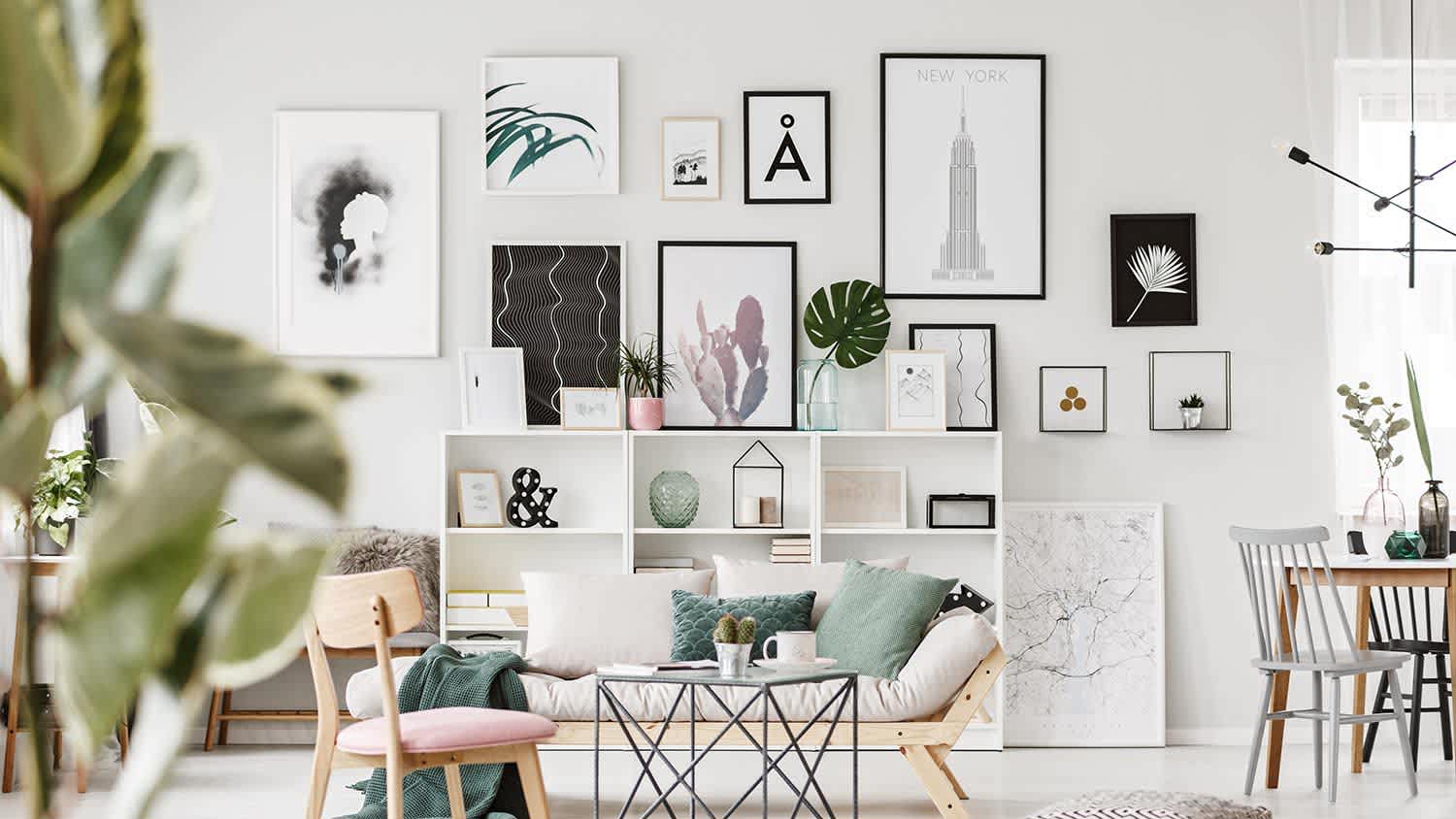 black and white drawings and paintings framed on the living room wall