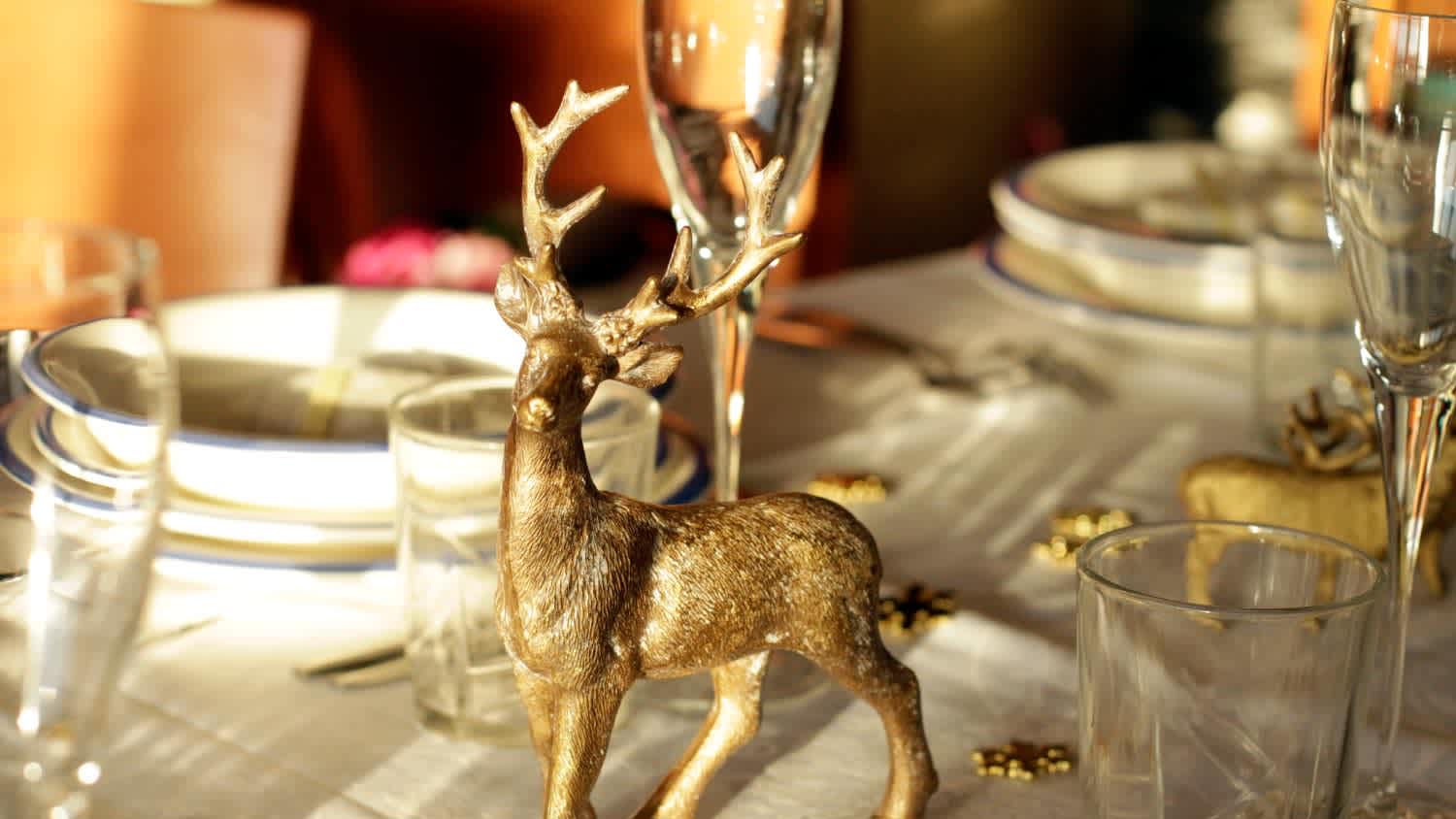 A golden reindeer decorating festive table
