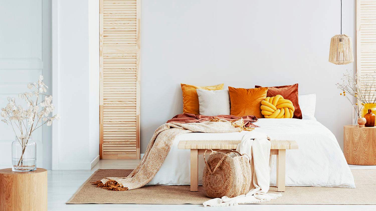 bed with white covers in well lit bedroom