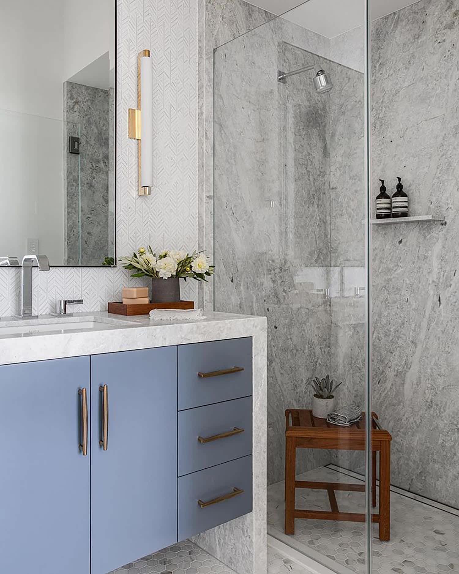 A slate blue vanity in a modern bathroom