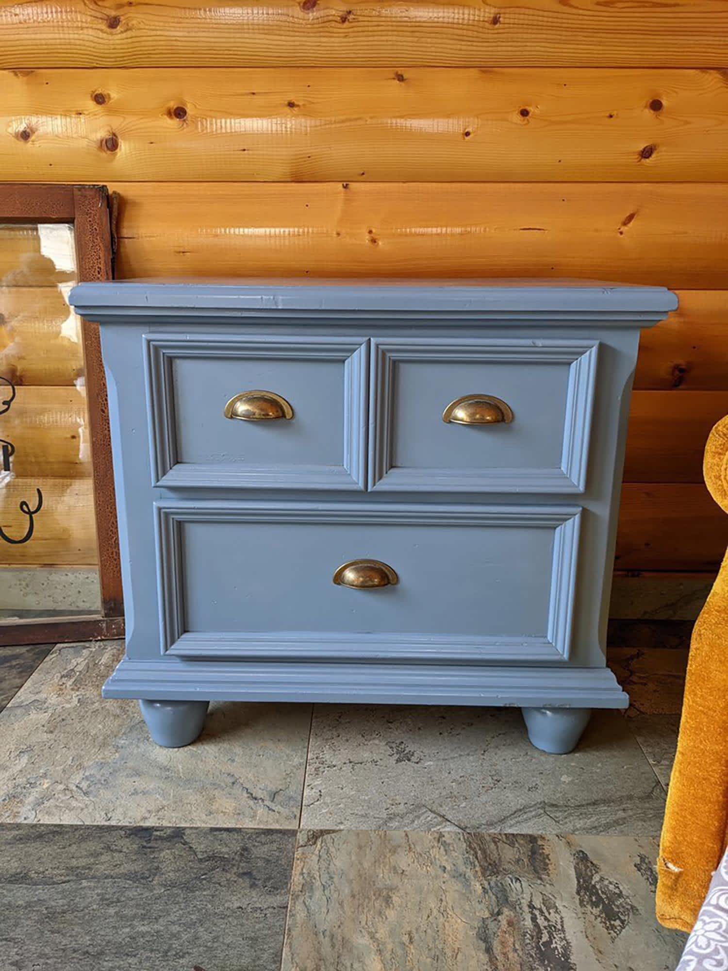 An updated slate blue painted nightstand