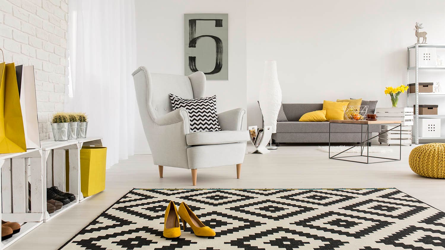 white chair in living room with black and white rug