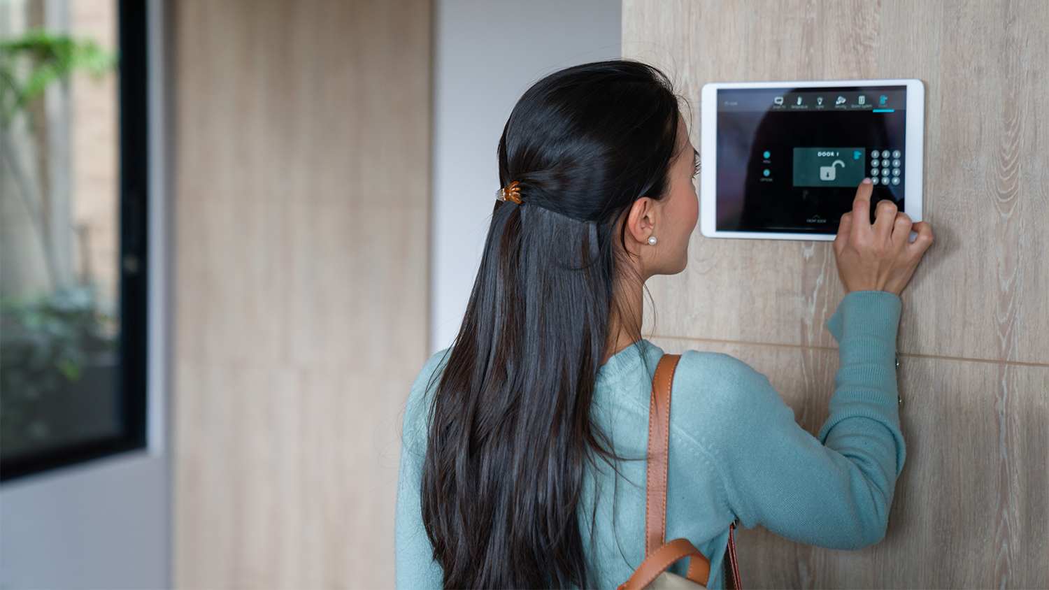 woman entering pin to smart lock door