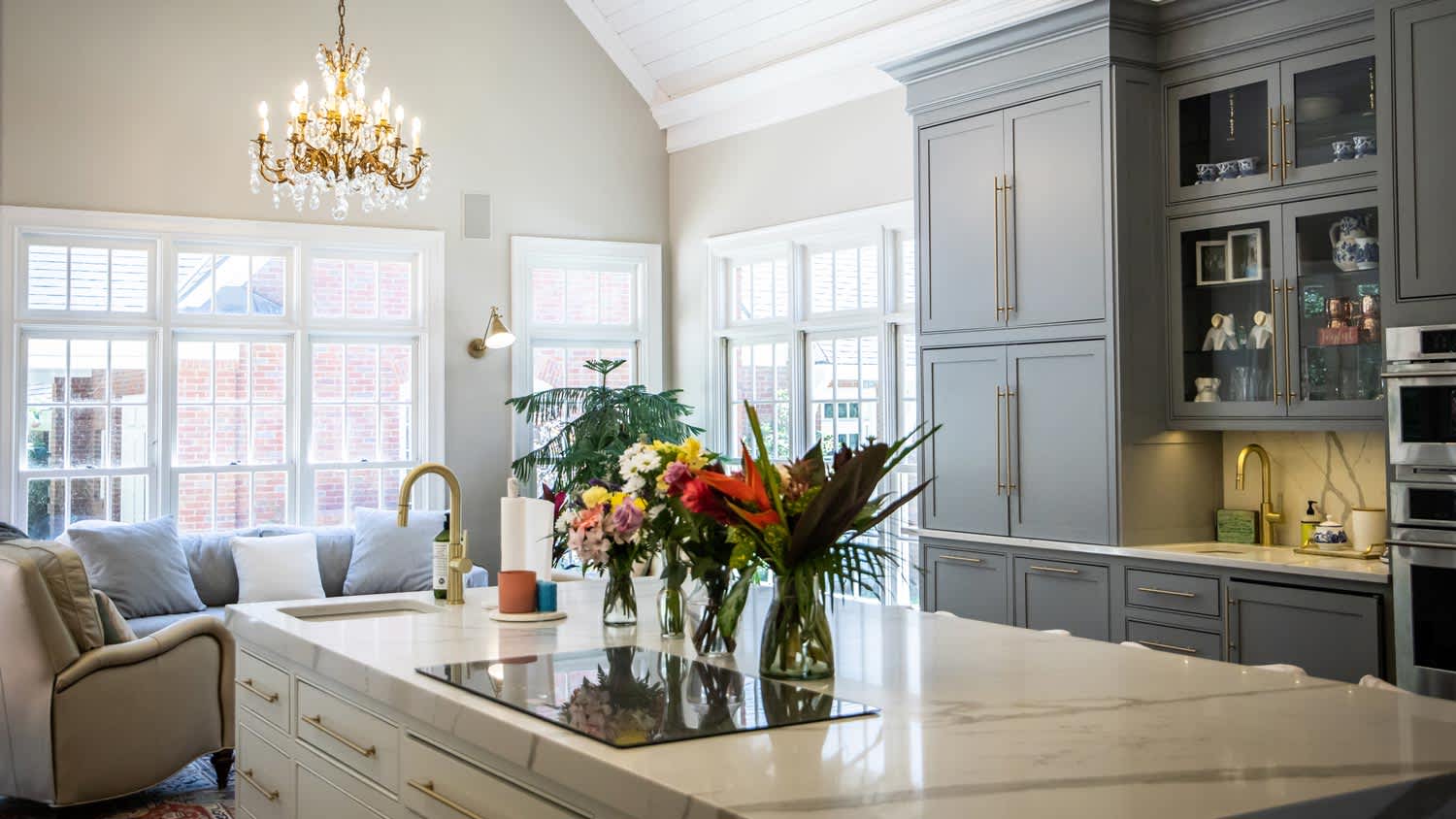 An open plan kitchen with a crystal chandelier