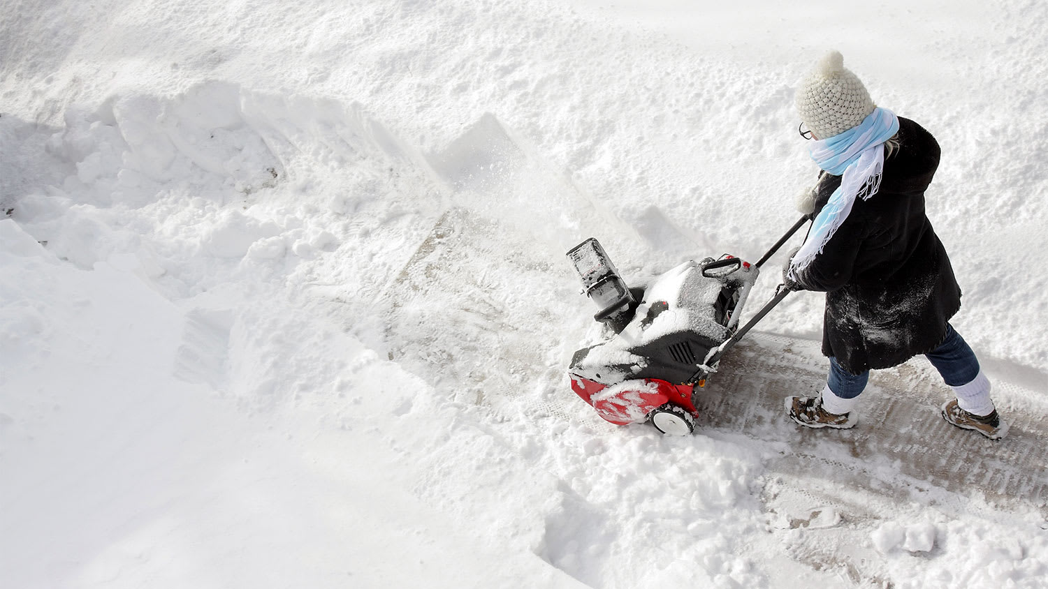 Woman pushing snow blower