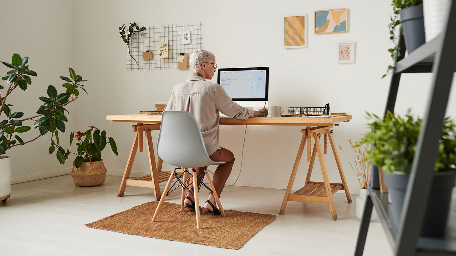 businesswoman sitting at a desk working in her home office