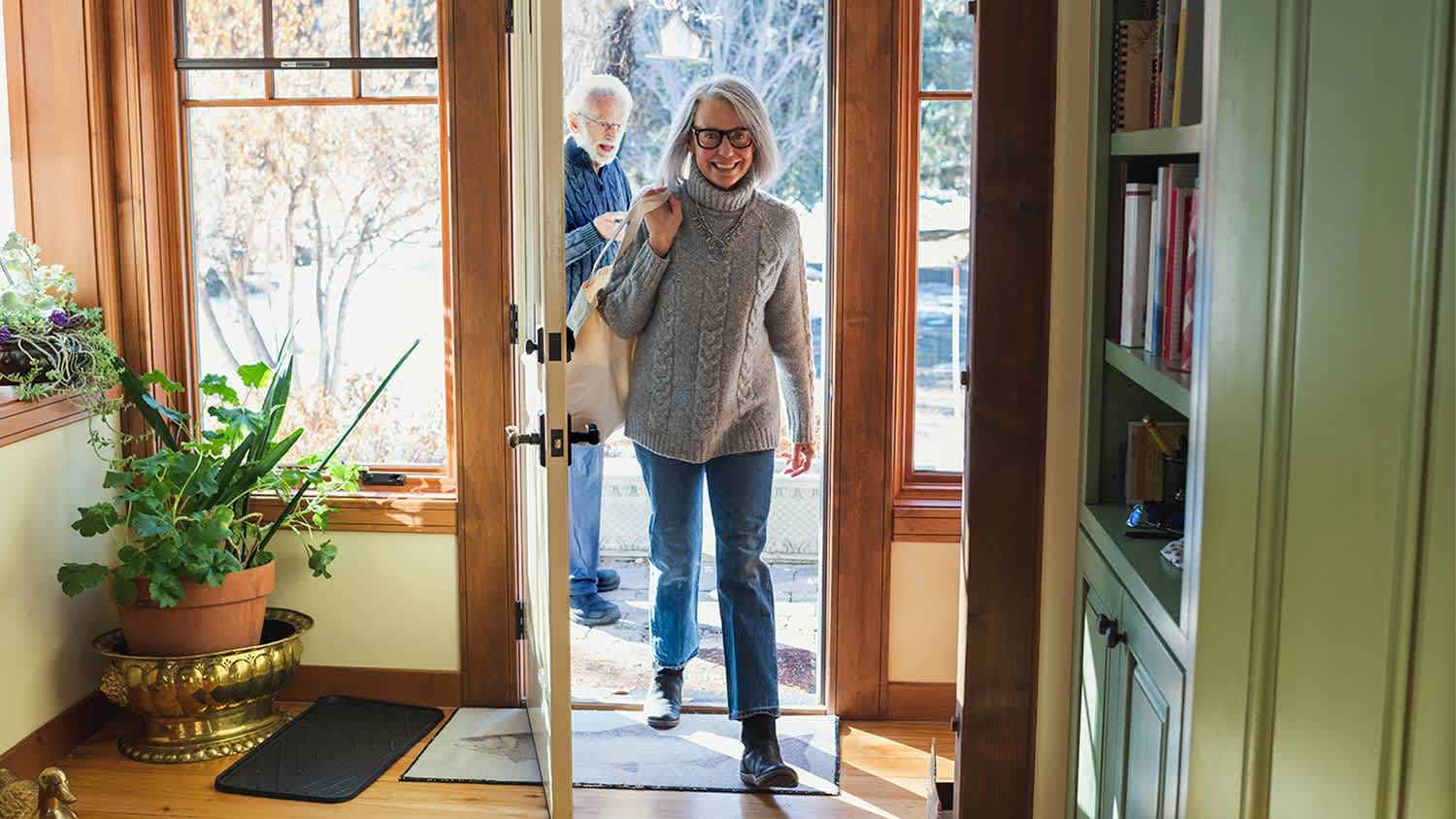 Couple walking through door of house