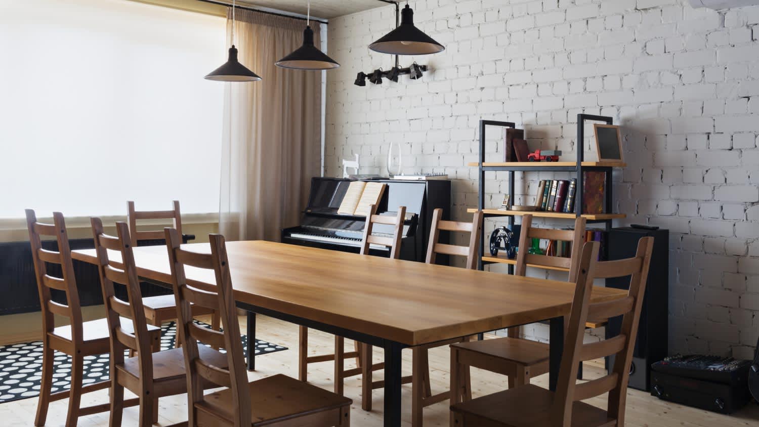 A wooden dining table and ladder back chairs