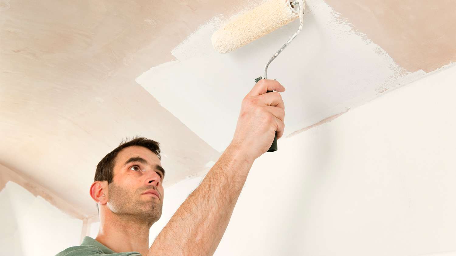 Man painting ceiling