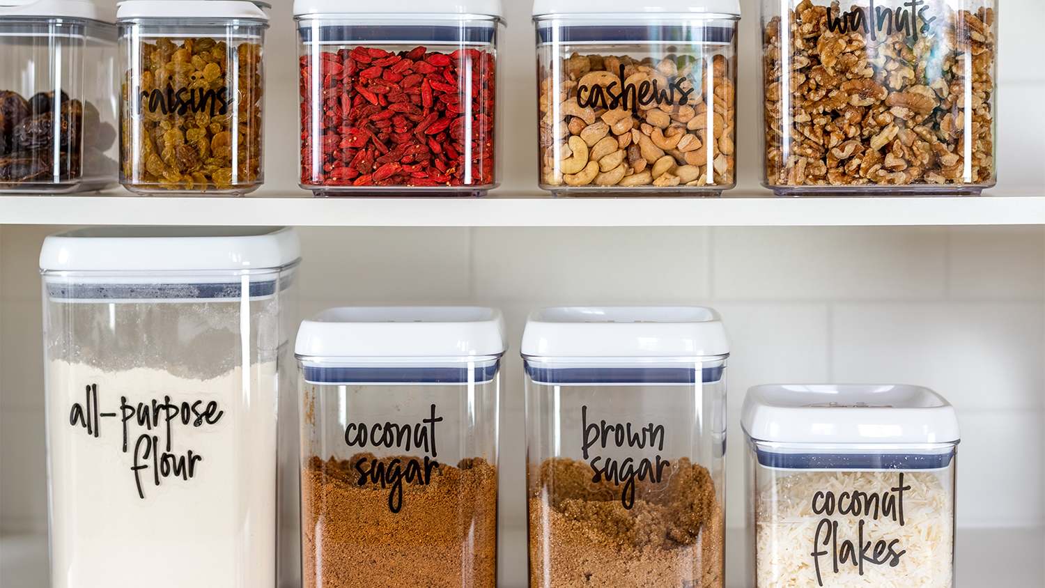 organized canisters with snacks in pantry