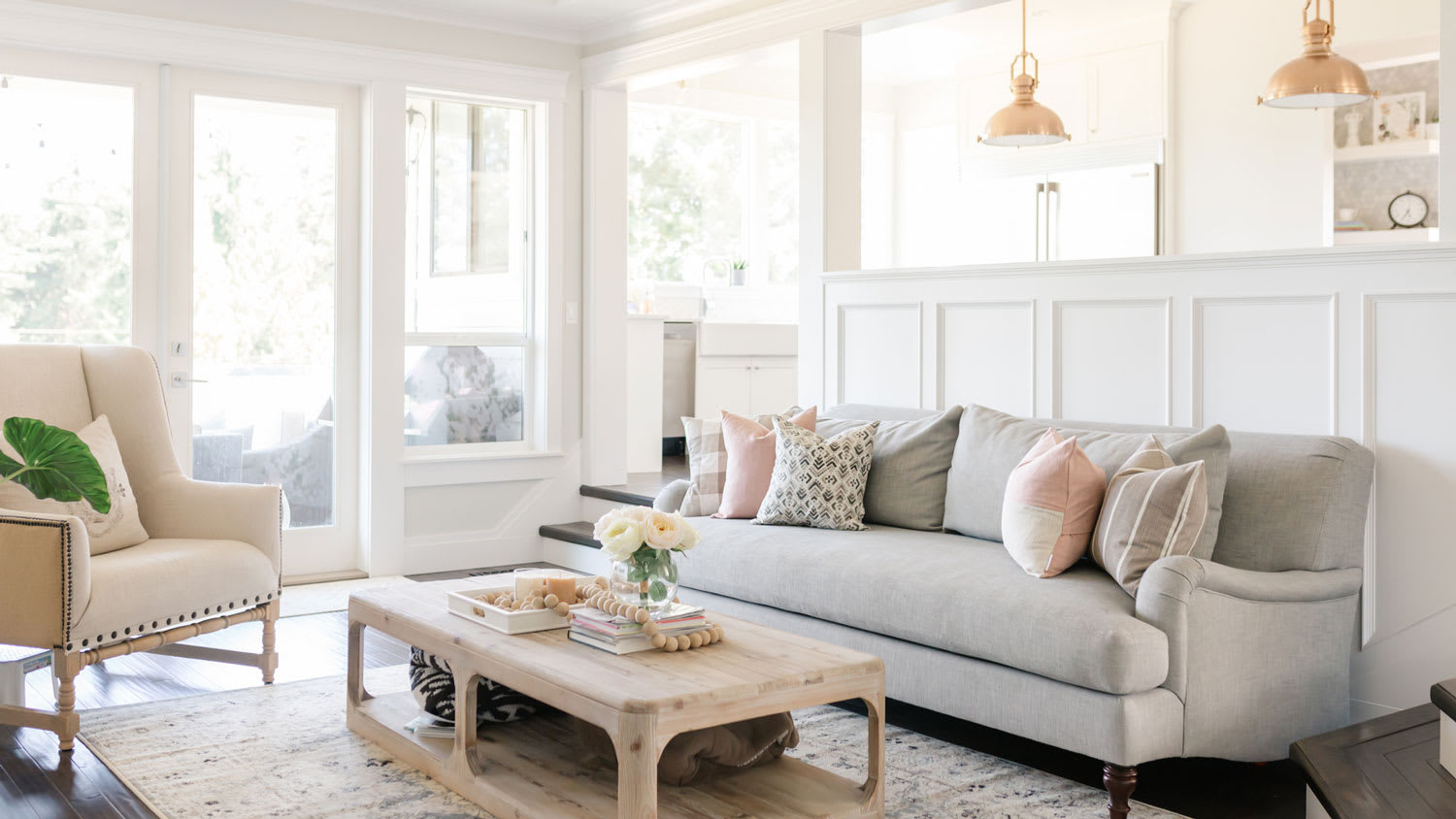 A bright living room with neutral tones and white walls