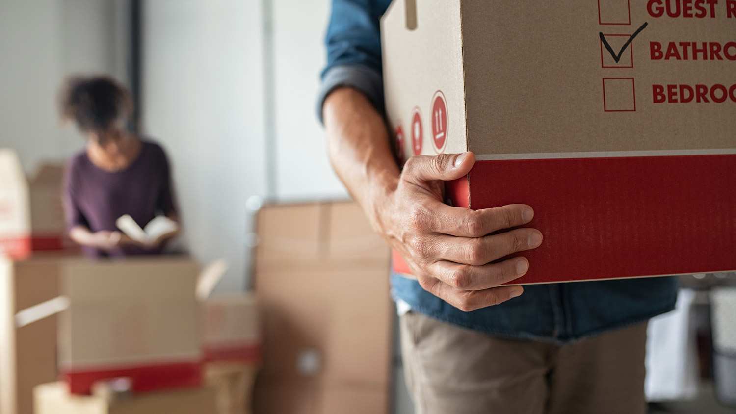 A man and a woman packing boxes