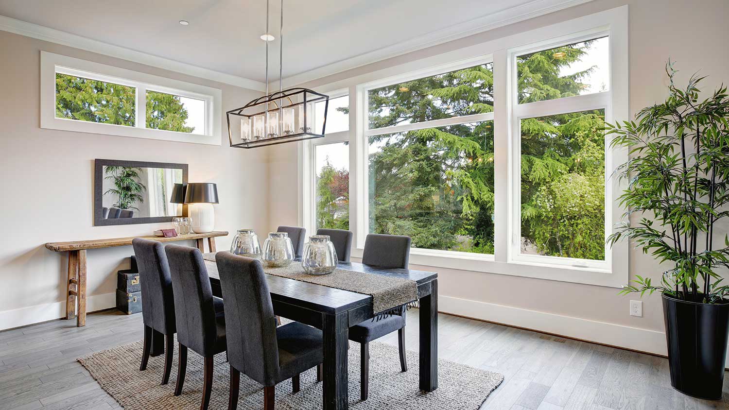 Modern dining room with black table and large window