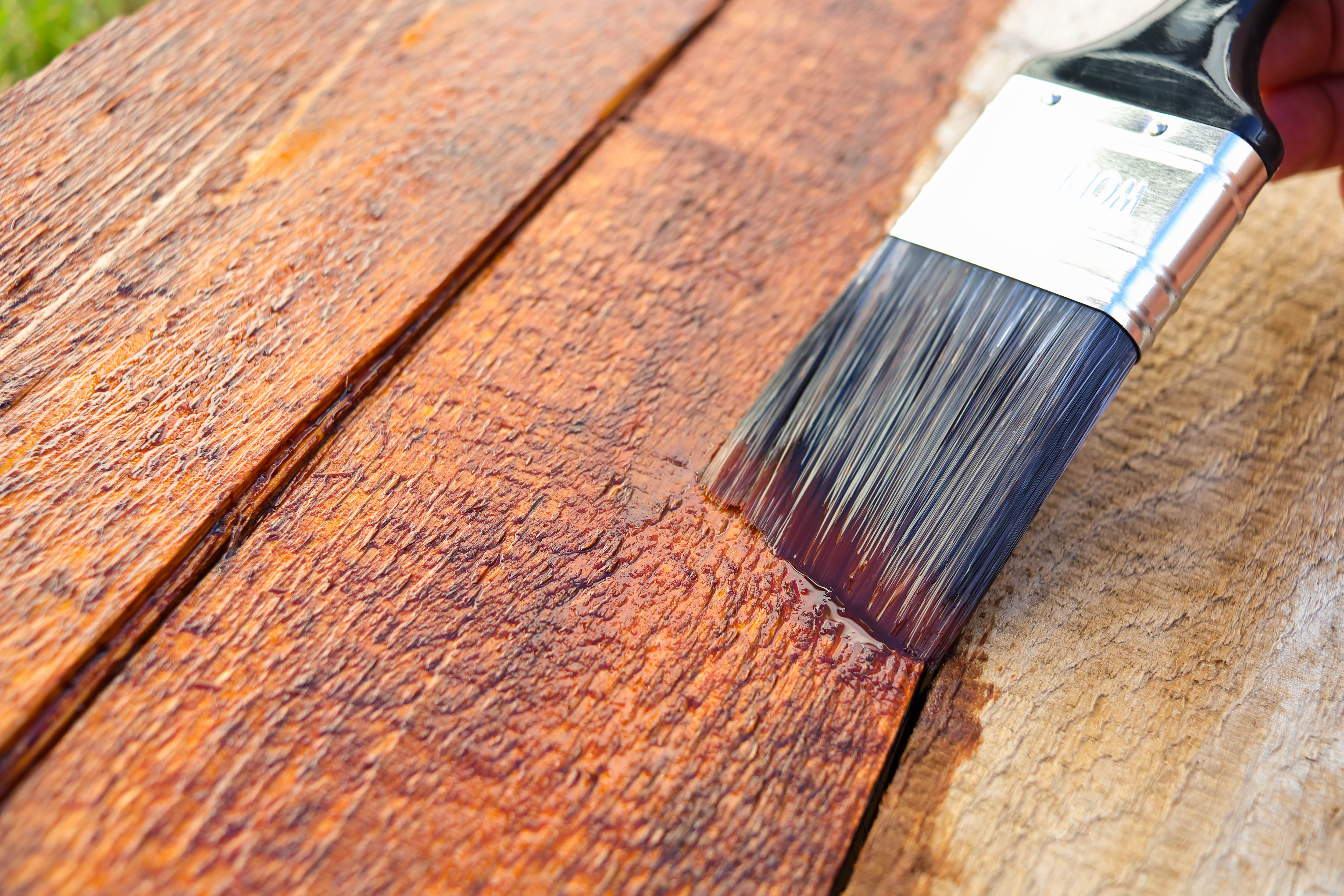 Staining wood with angled paintbrush