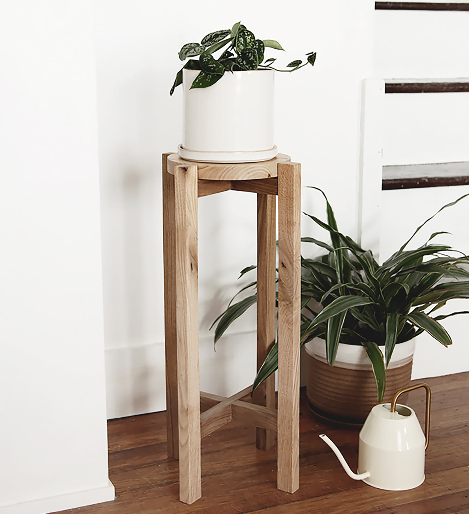 Tall wooden planter plants watering can