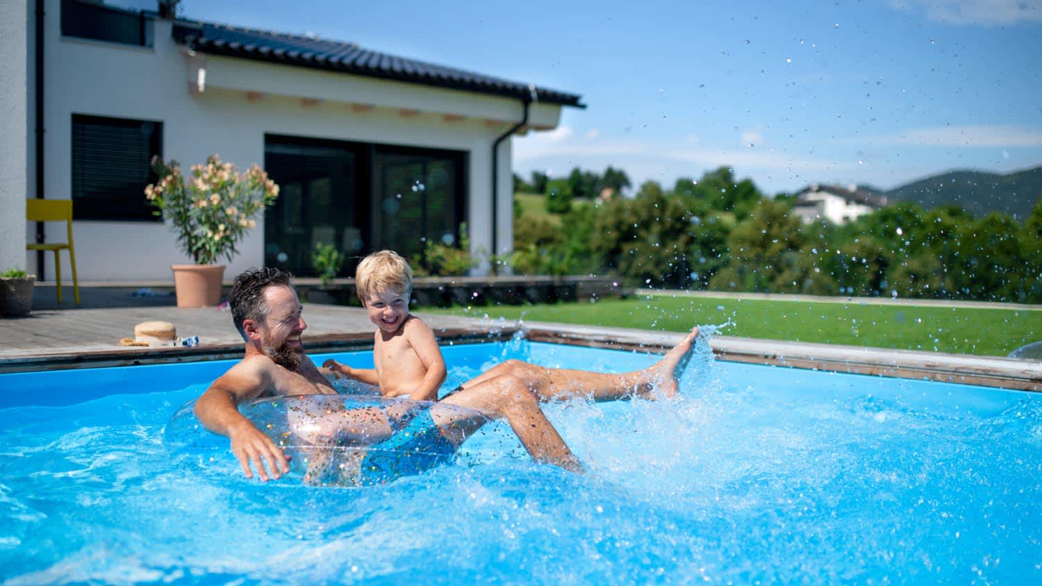 Father and son playing in the swimming pool