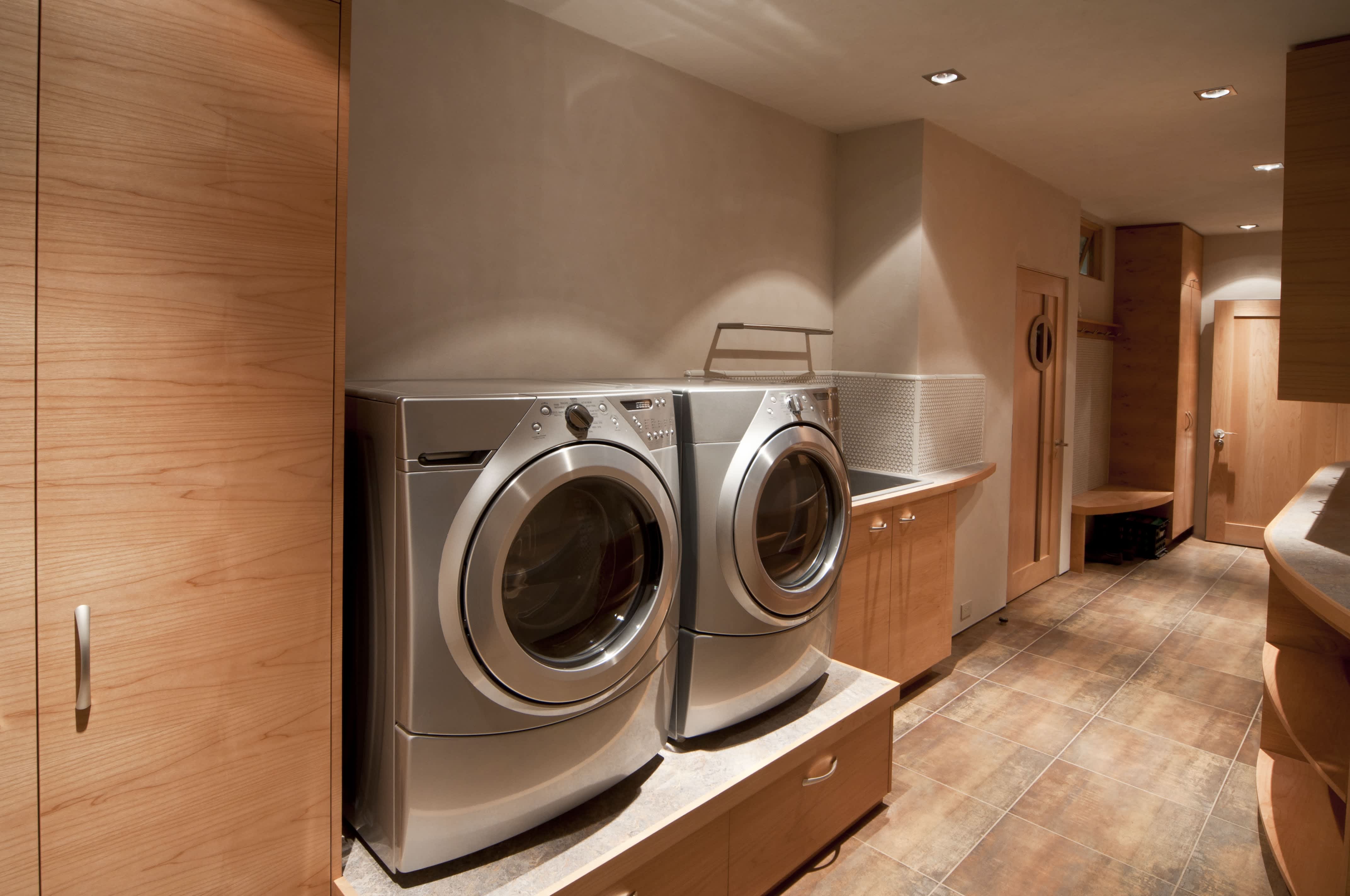Large laundry room with washer and dryer on pedestal