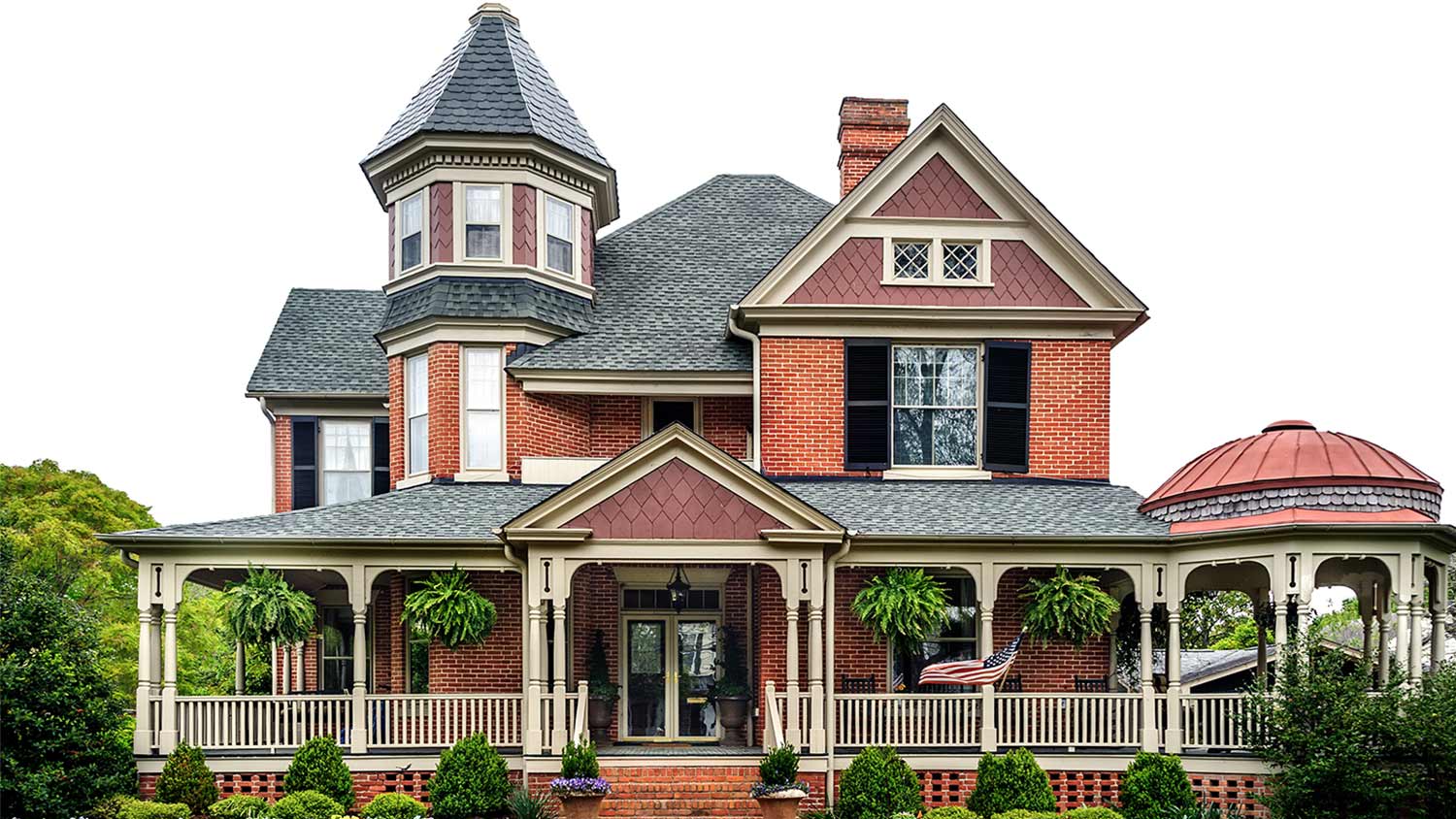 Red victorian house porch plants