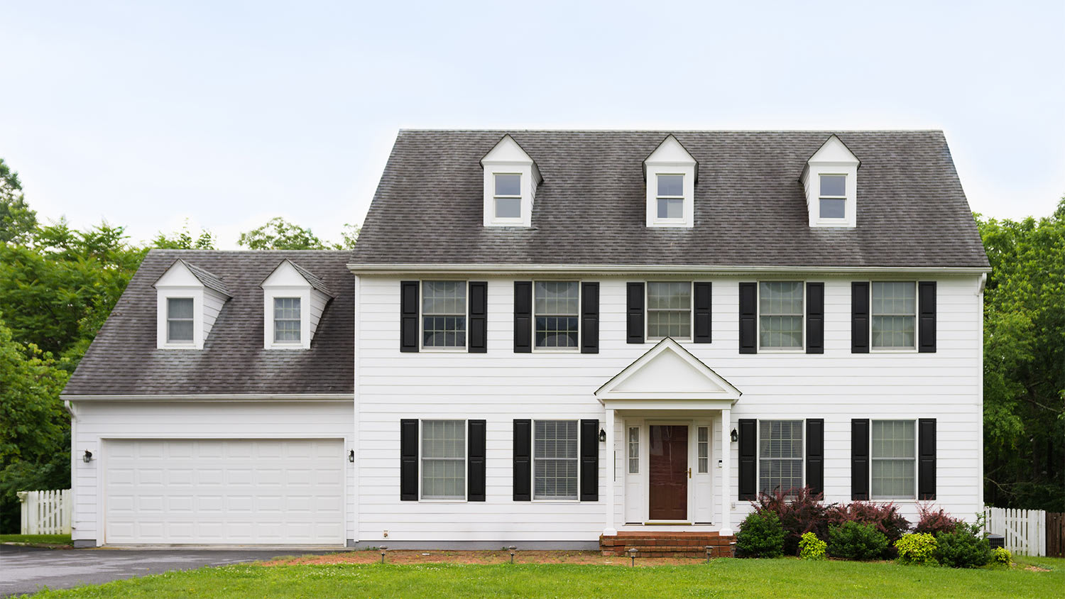 White colonial house yard
