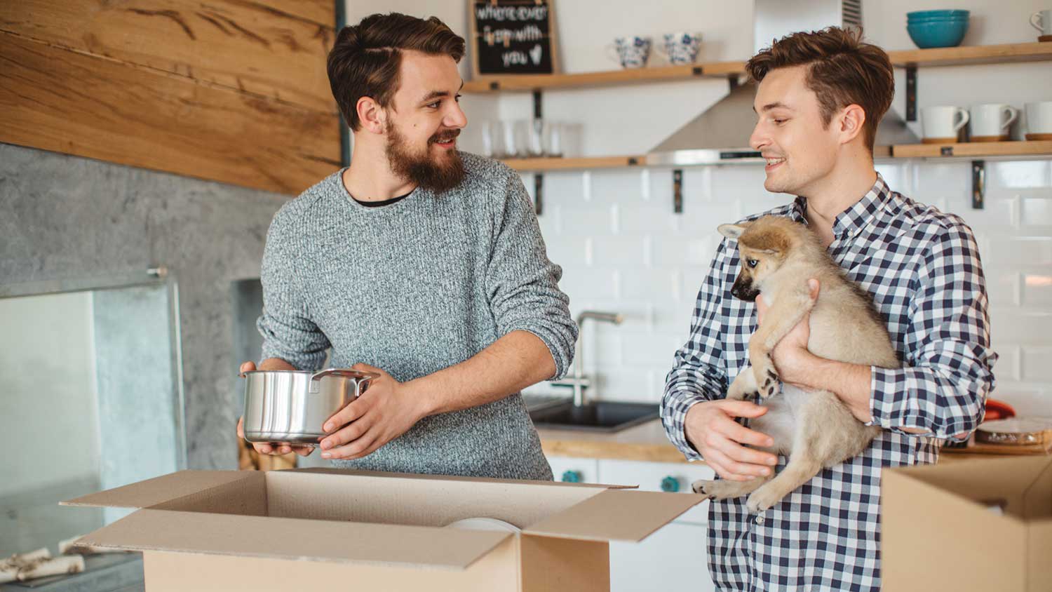 Man packing sauce pan in a cardboard box