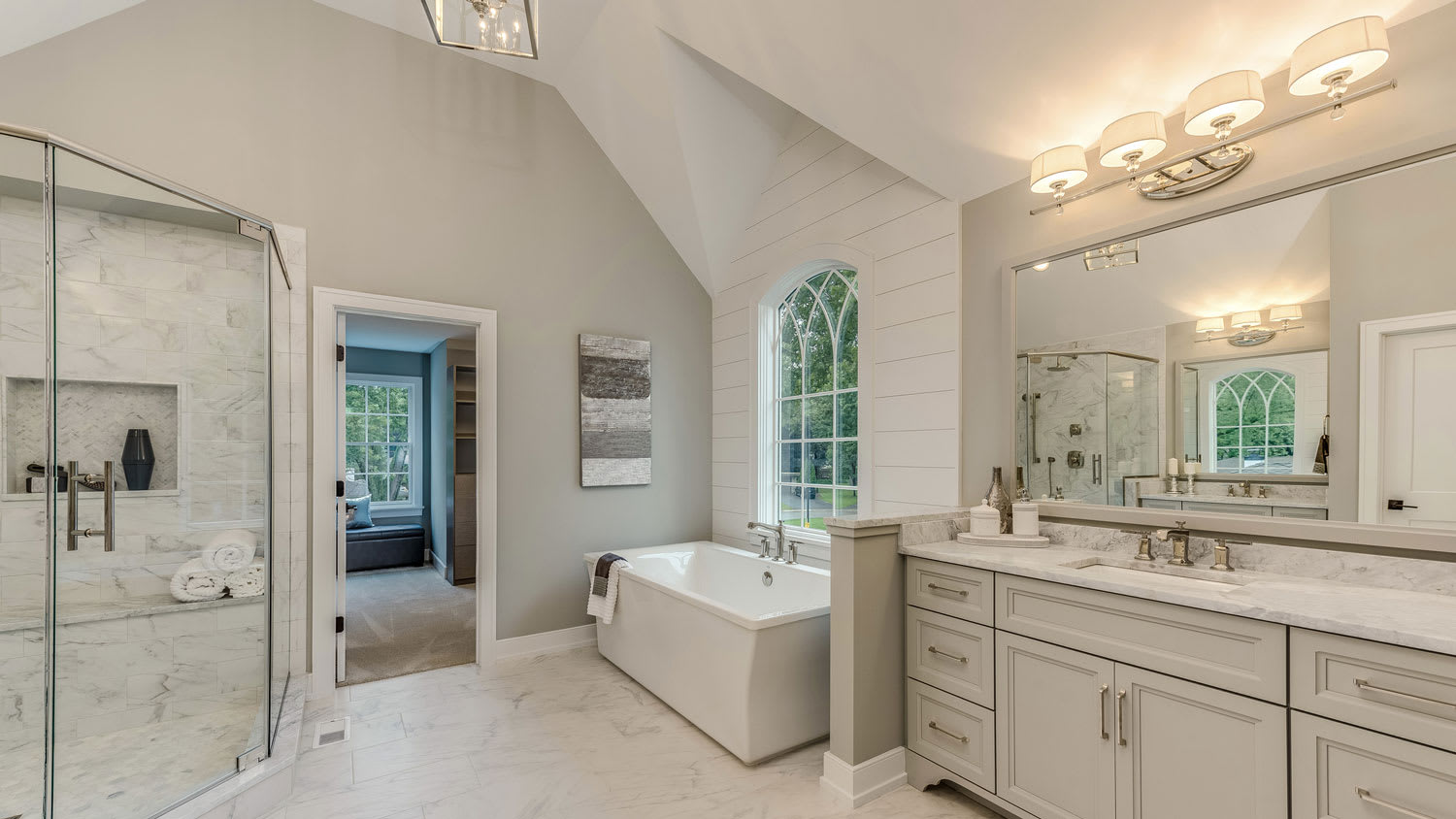 A master bathroom with track lighting