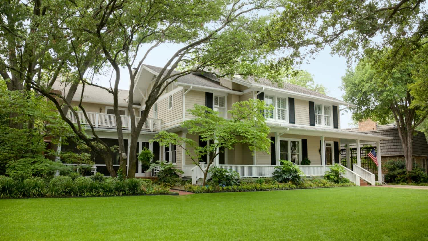 View of residential home with large green front lawn